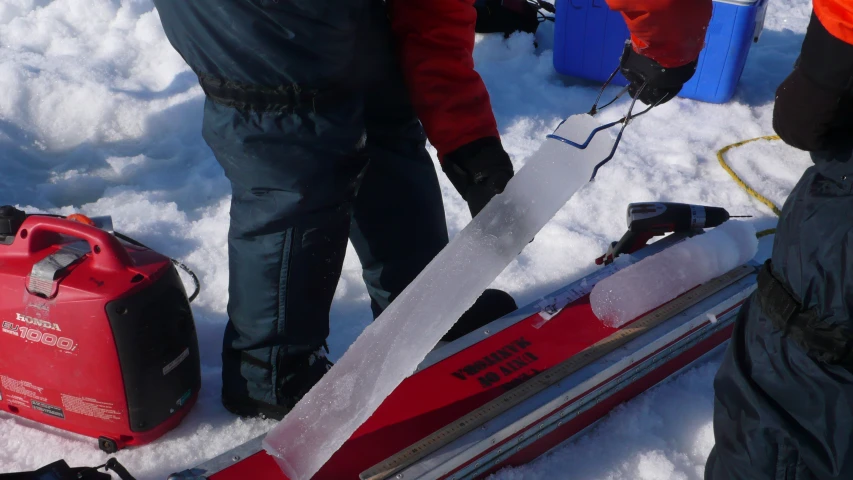 a man is standing in the snow next to his ski gear