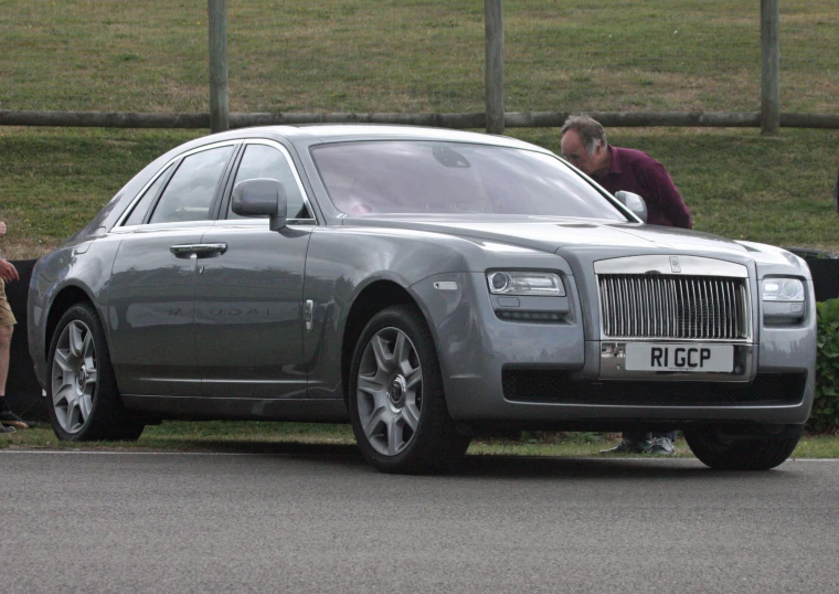 a silver vehicle parked on the side of a road