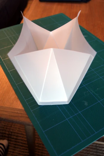 a close up of a folded origami object on top of a table