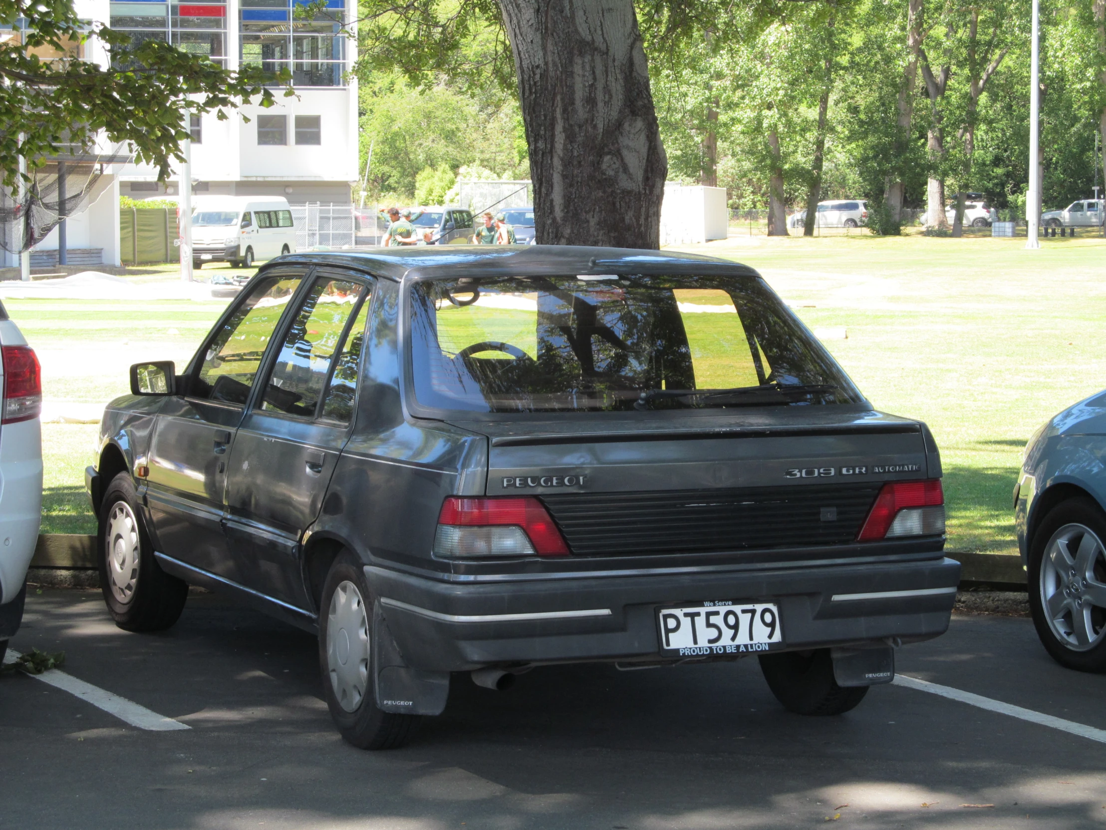 a couple of cars sitting parked in a parking lot