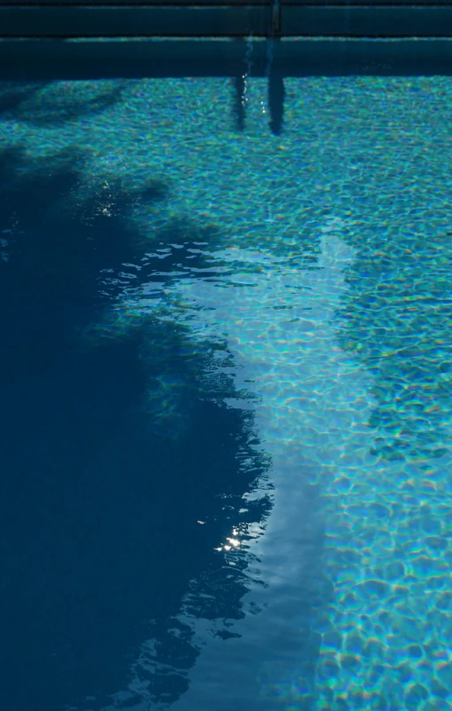 an in swimming pool with water reflecting off of the edges