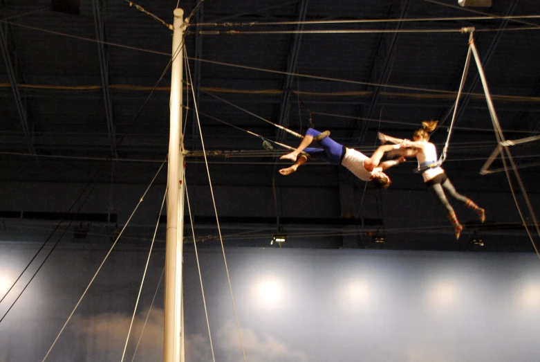 two people on aerial aerial trampoline doing tricks