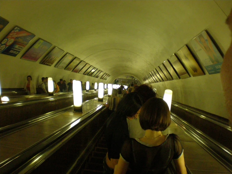 a couple of people that are on some escalators