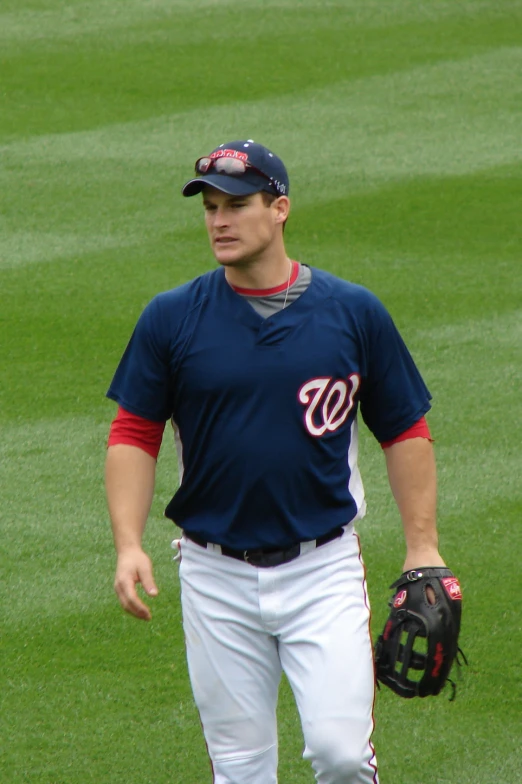 a man with a hat and glove standing on a field