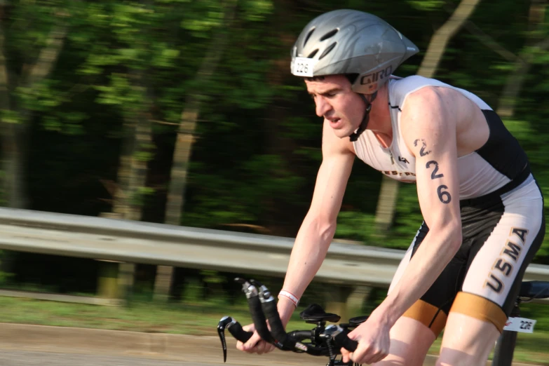 a man riding a bicycle wearing an upside down helmet