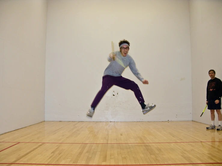 a man jumping up in the air on a tennis court