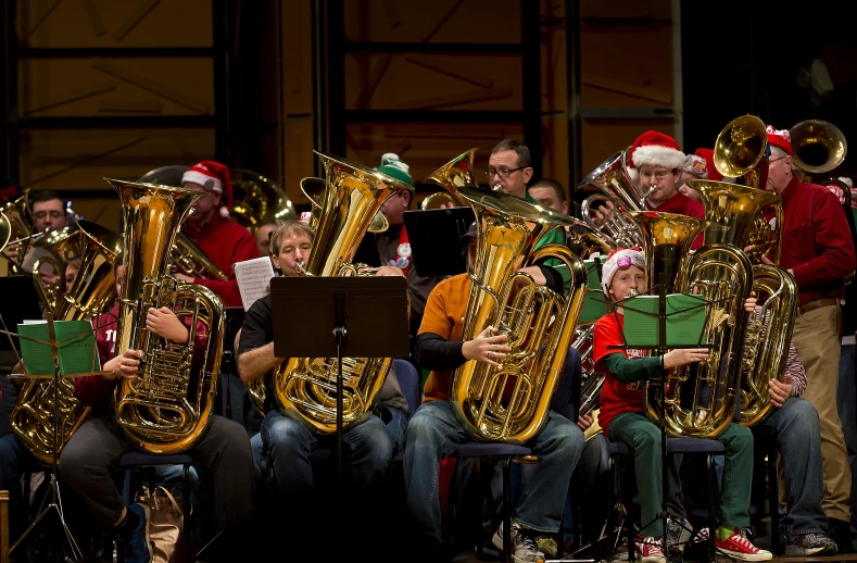 a band is playing musical with christmas decorations