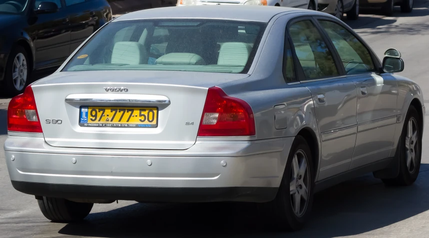 the rear view of a parked car on a busy city street