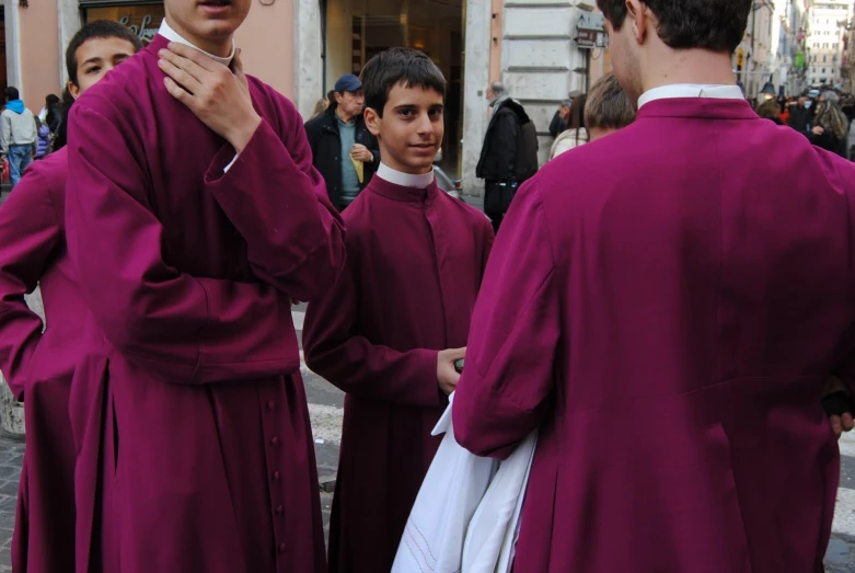 a group of men standing next to each other in purple robes