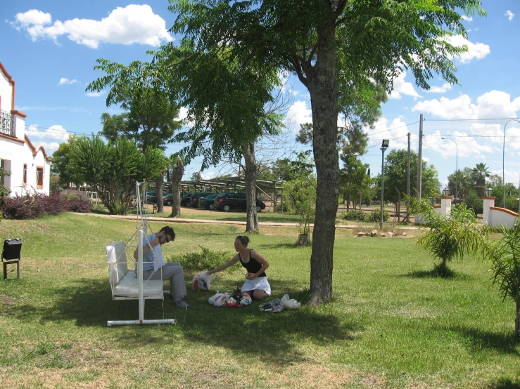 a man and two children sitting on a chair in the grass