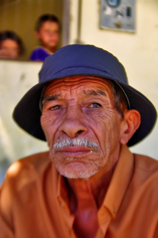 a man wearing a hat and a tie