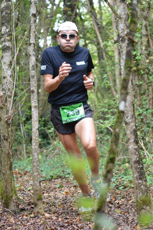 a man running in the woods on a trail