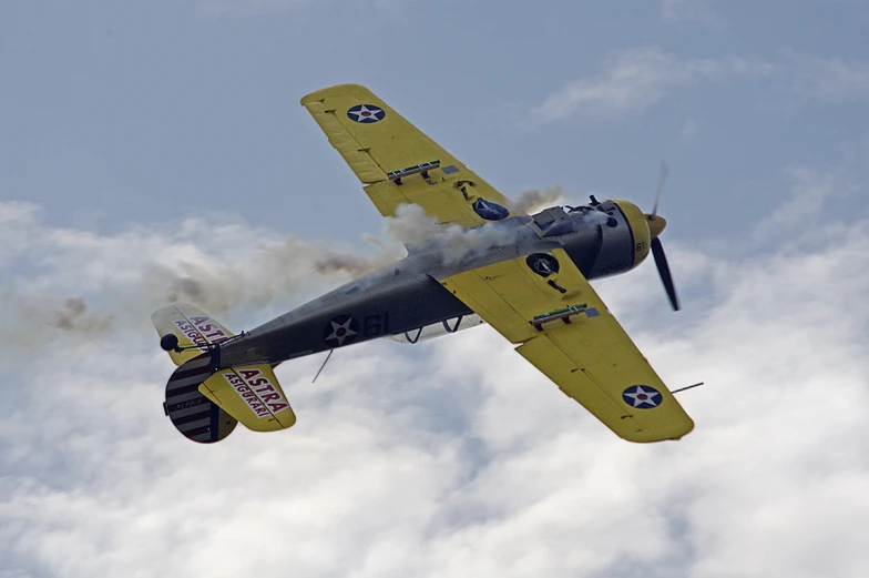 an old style airplane flying through the sky