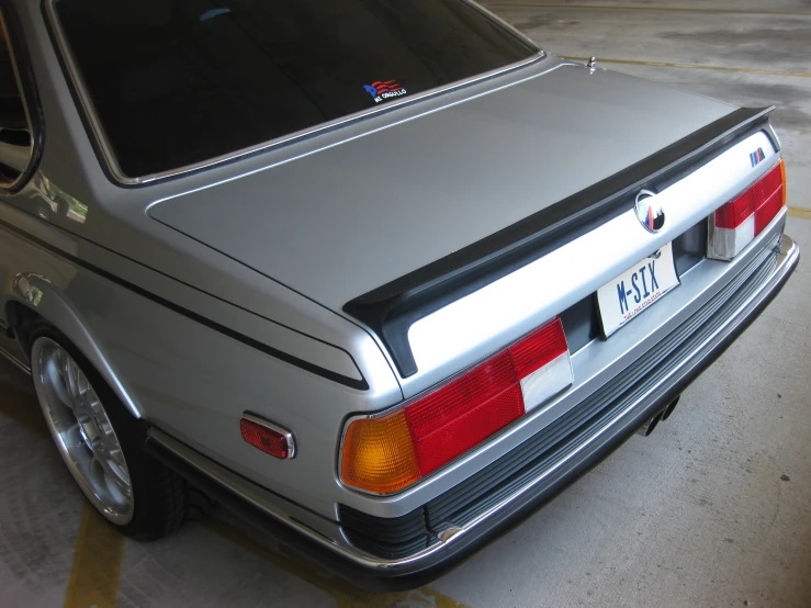 silver bmw in a parking space with no people around