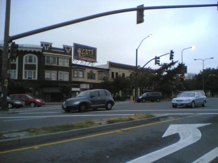 cars are stopped at a red light to pick up pedestrians