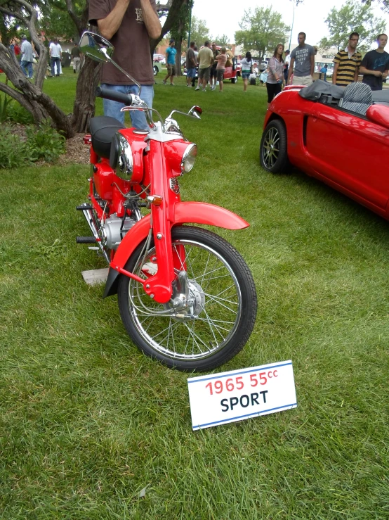 a vintage motorcycle is on display near a red sports bike