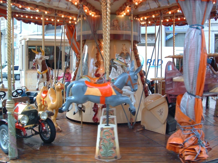 a merry go round in a town square with all the rides and fixtures