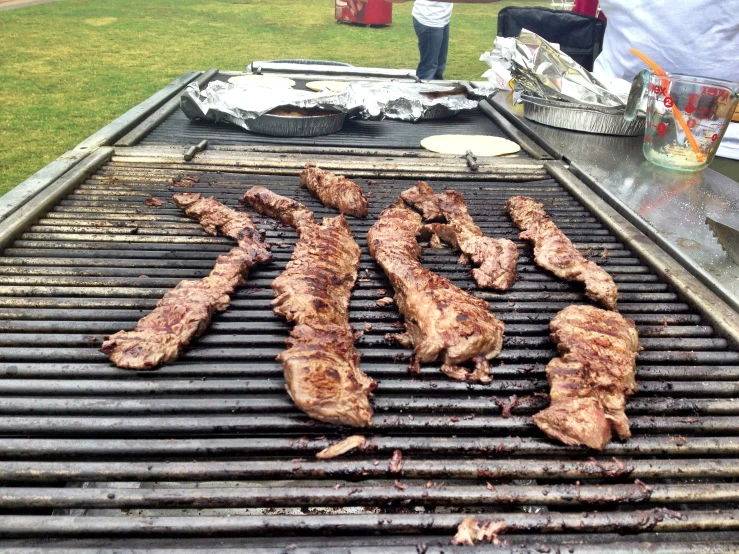 three pieces of steak sitting on top of a grill