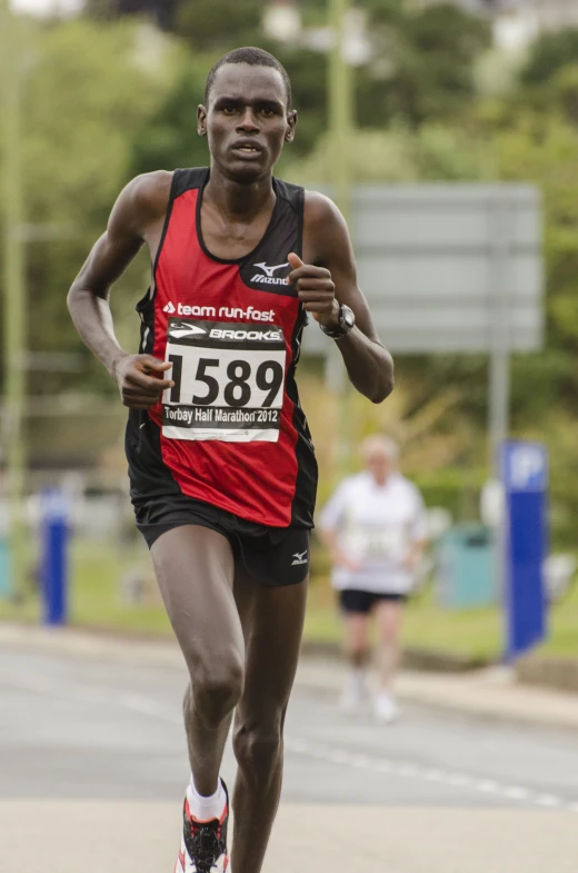 a man running in the race with a number plate on his chest
