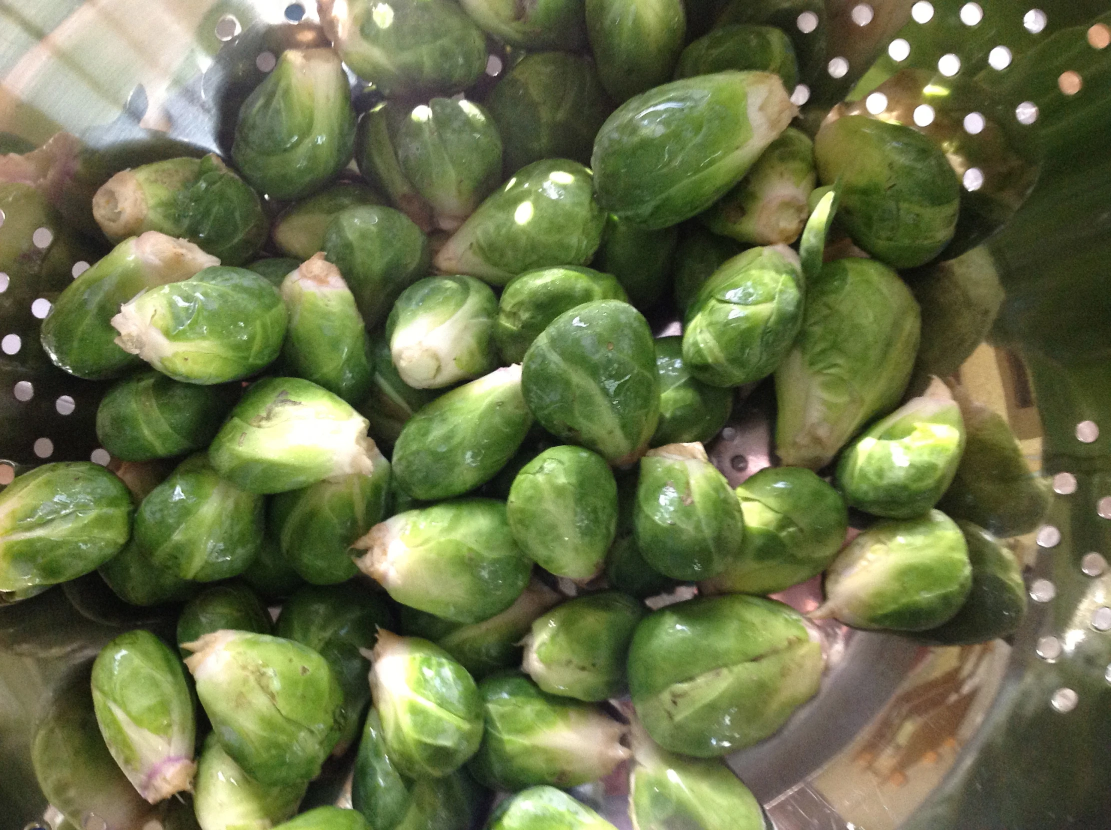 brussel sprouts are cooked in a strainer