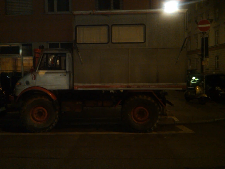 a large truck on a city street at night