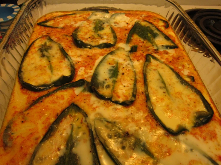 a dish with cheese and vegetables arranged on it