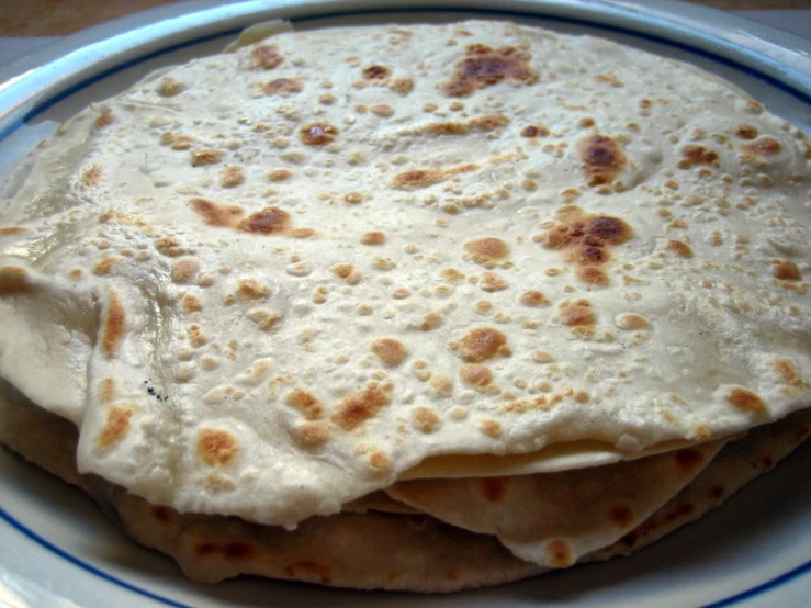 some white food on a plate with a spoon