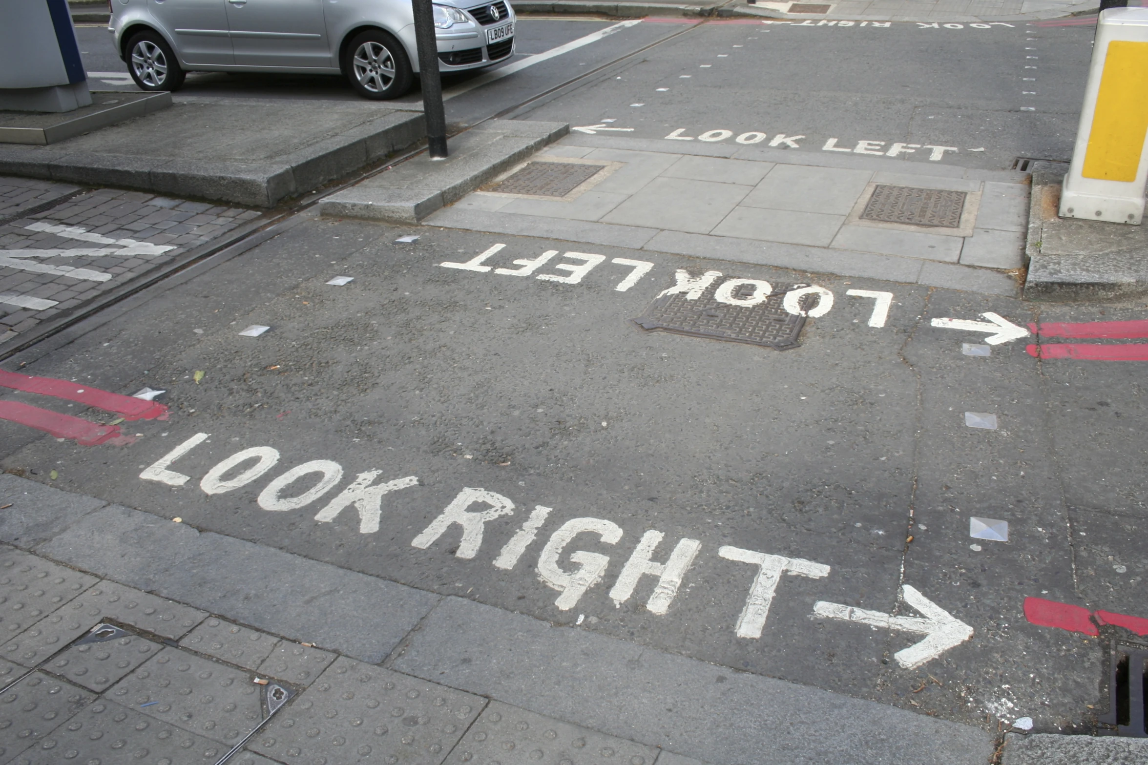 an arrow marked with white chalk on a street