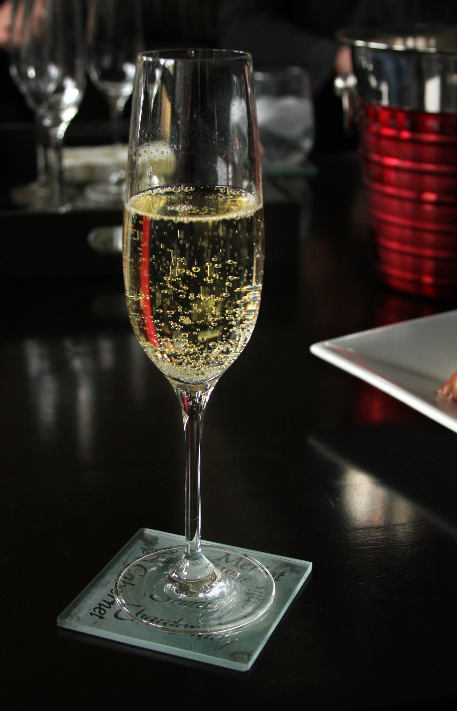 a glass of wine sitting on top of a table