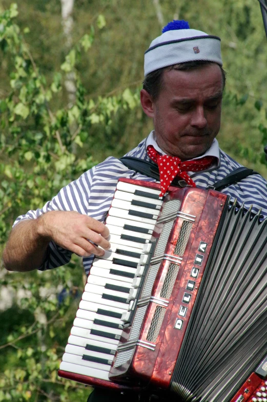 a man in a bow tie playing an accordion
