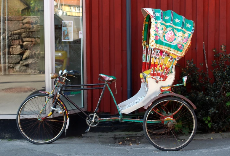 a horse - drawn tricycle with a dragon decoration on the front