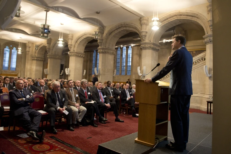 a man giving a speech to an audience