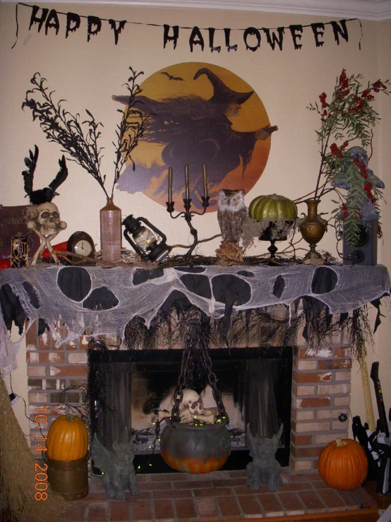 an ornate halloween mantle with decorations and skulls
