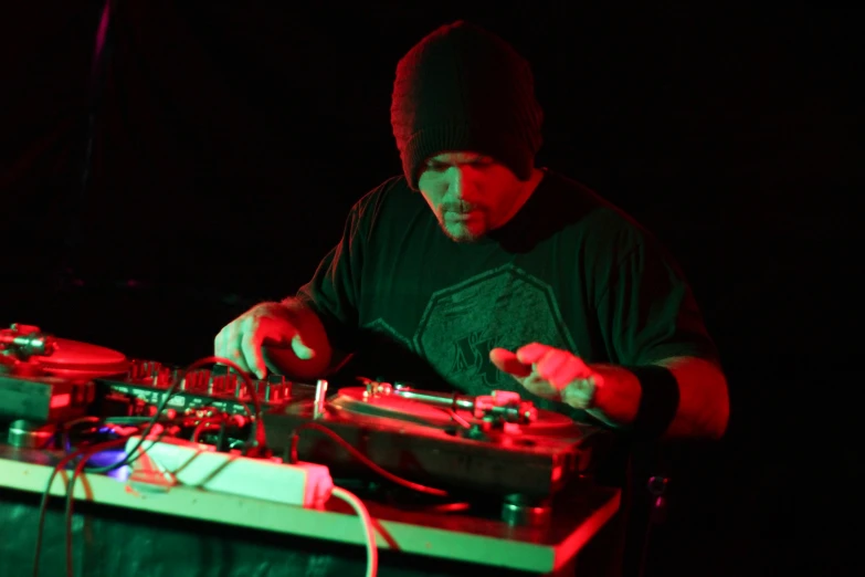 a dj spinning on his turntable at a concert