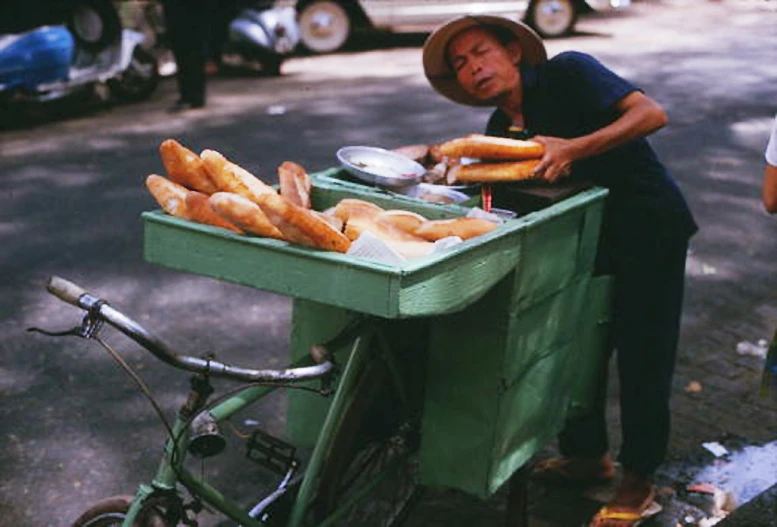 a man is selling food on a cart