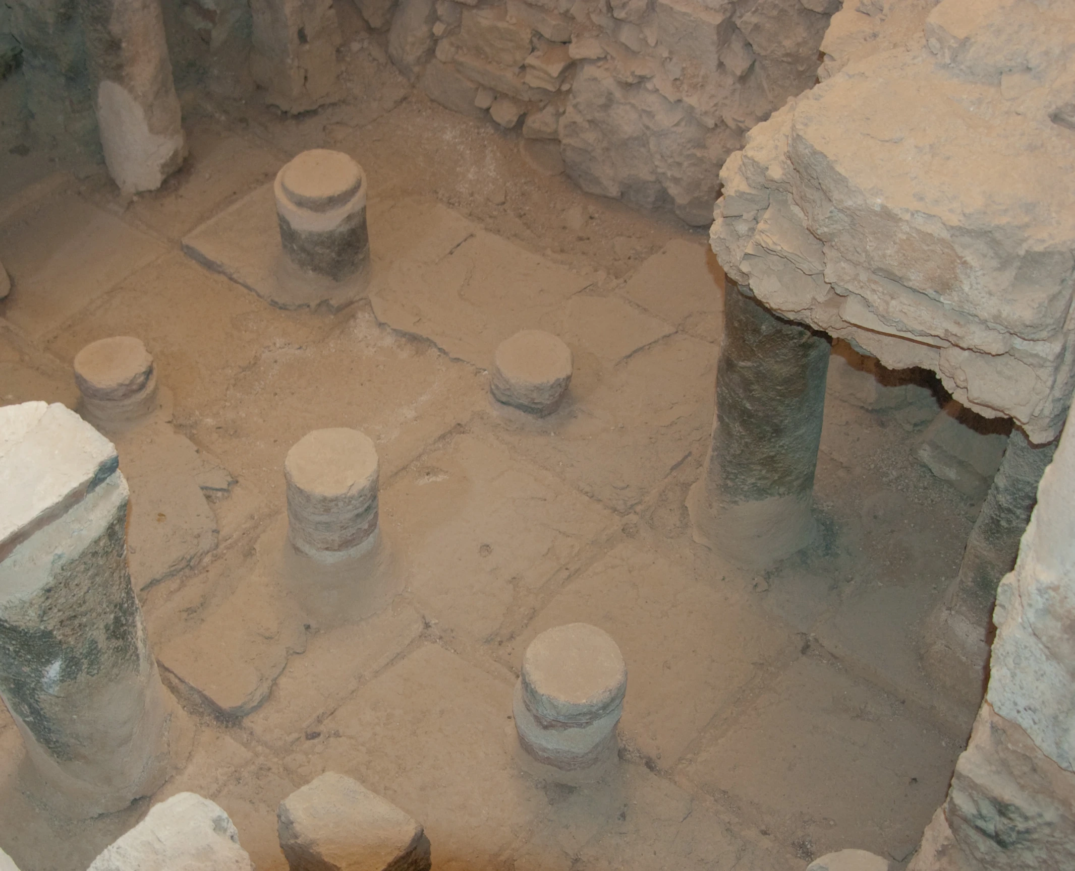 several stone jars are stacked together in a room