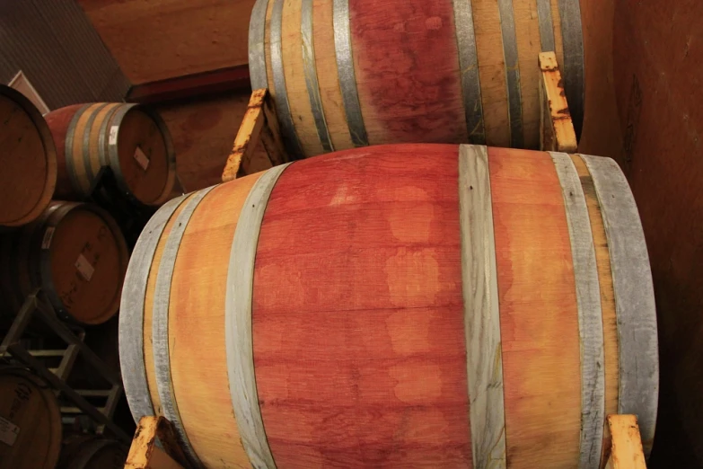 several wine barrels stacked in a wine cellar