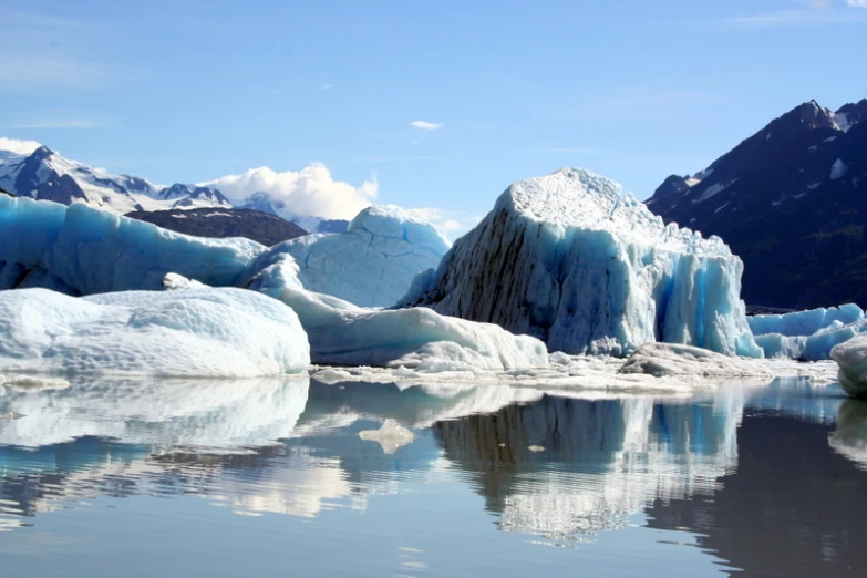 several ice blocks floating on top of a body of water