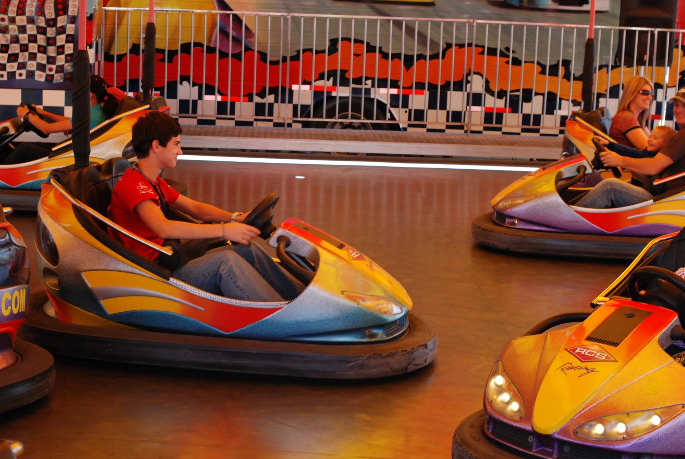 a small group of people ride around in bumper cars