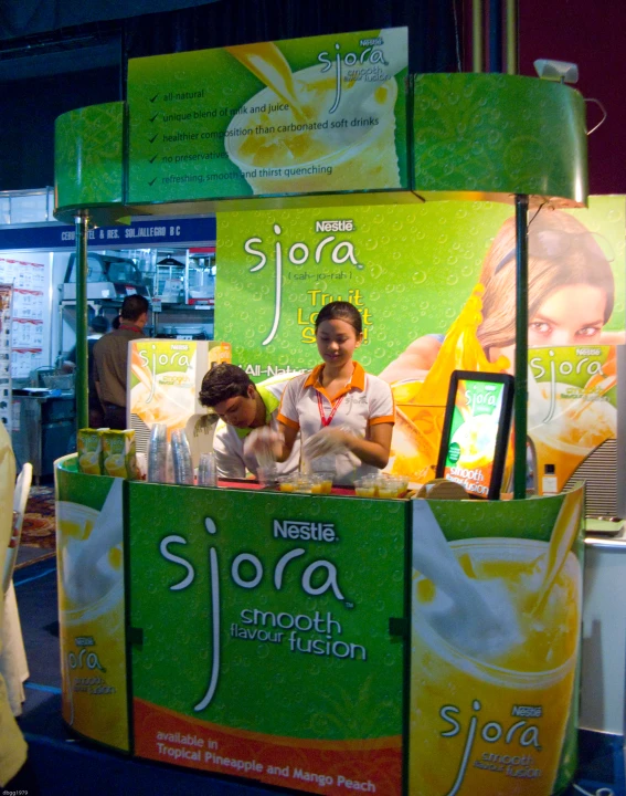 a woman standing behind a display that sells soap