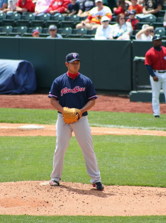 a baseball player stands on the mound in a stadium