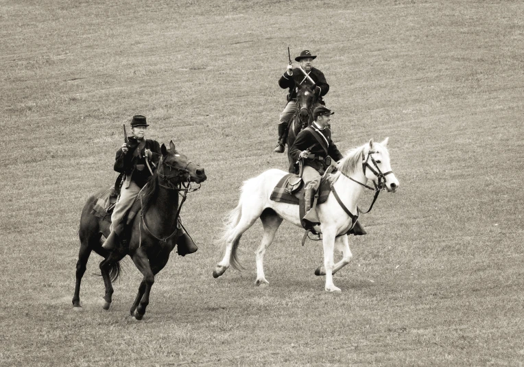 two people riding horses next to each other