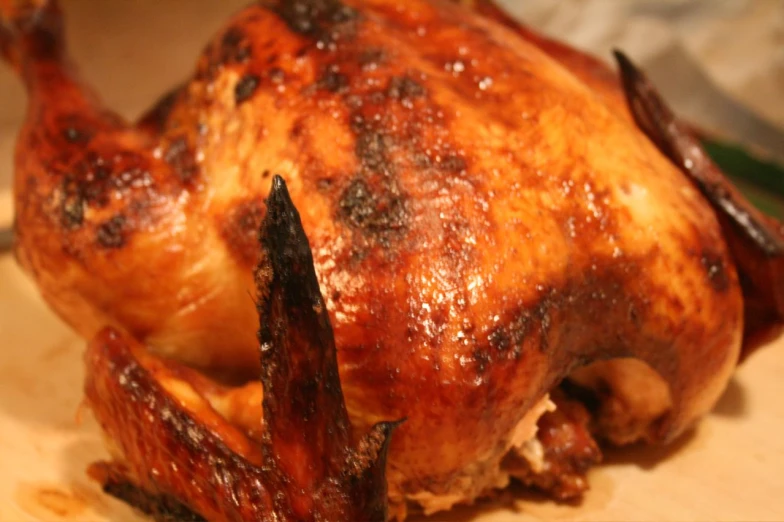 a cooked chicken sits on a  board