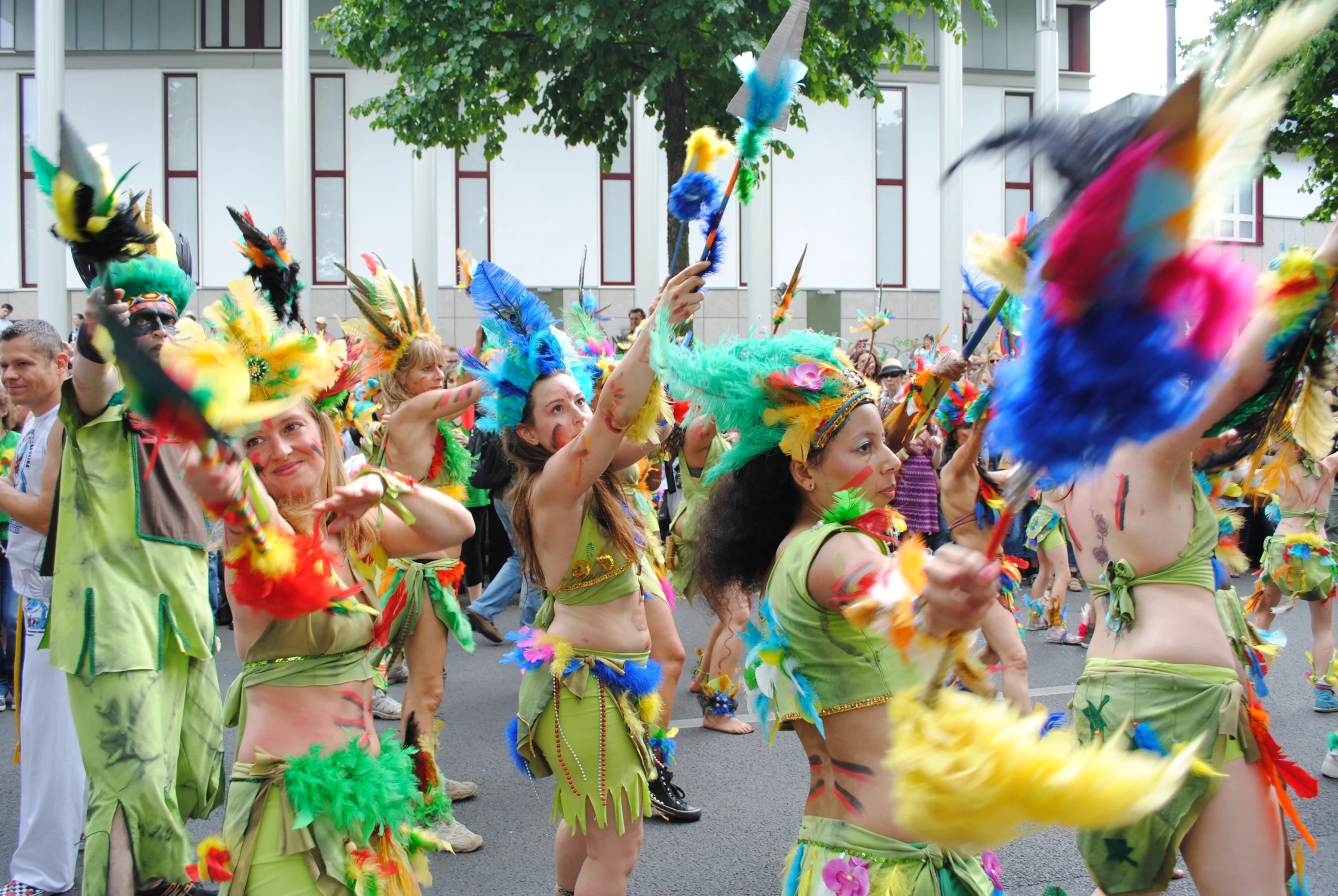 a group of women in costumes dance on the street