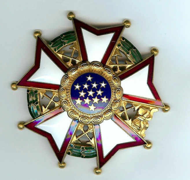 a golden medallion with two stars in the middle of it