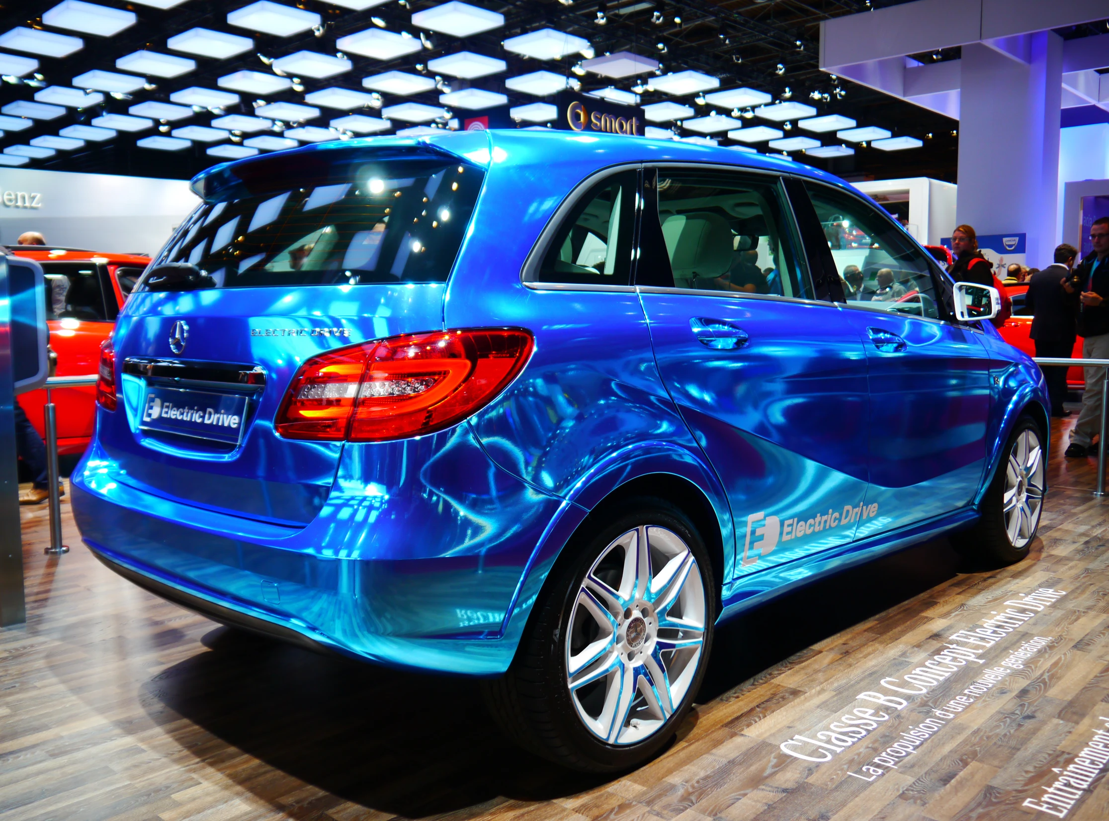 a blue colored vehicle parked on display in a building