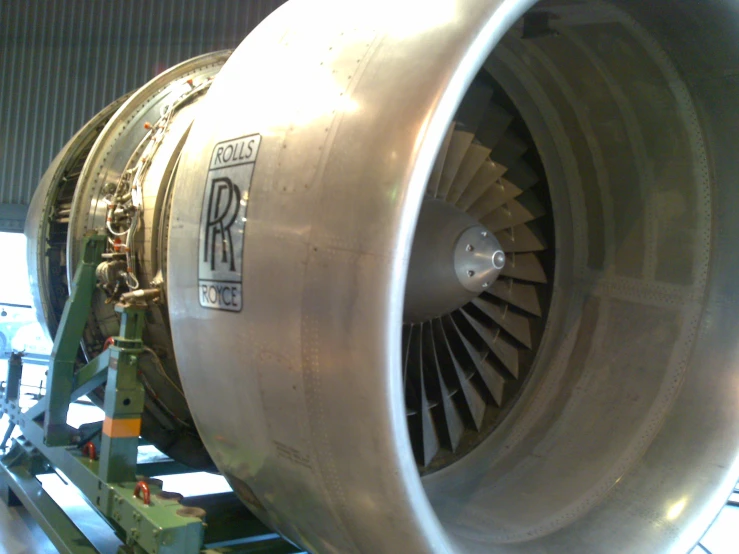 a jet engine sits in the middle of a hangar