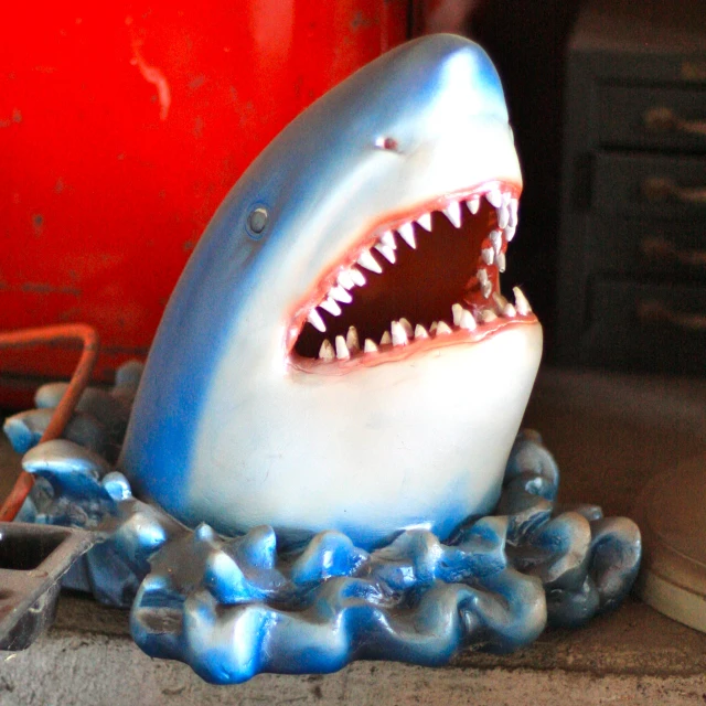 the blue toy shark has its mouth open
