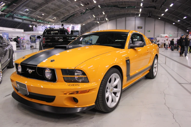 the yellow sports car is sitting in the showroom