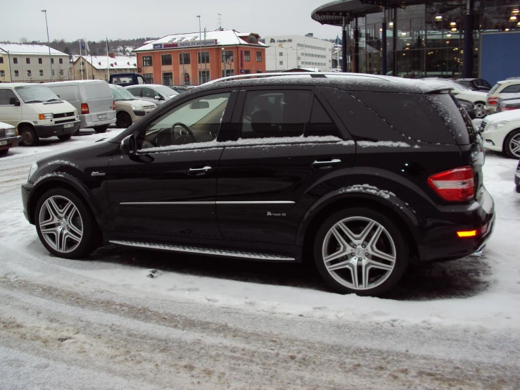 black car parked outside a building near snow